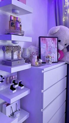 a white teddy bear sitting on top of a dresser next to a purple shelf filled with cosmetics