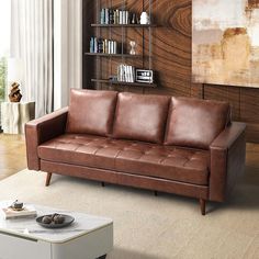 a living room with a red leather couch and coffee table