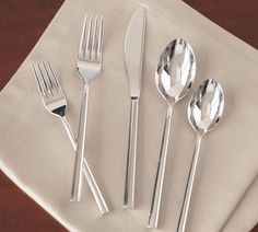 silverware is laid out on top of a napkin