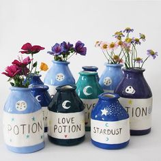 several vases with flowers in them sitting on a table next to each other and the words love, potton, stardust