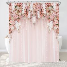 a shower curtain with pink and white flowers hanging from it's side, on top of a rug