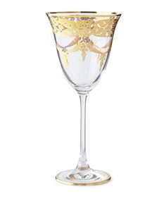 a wine glass with gold designs on it