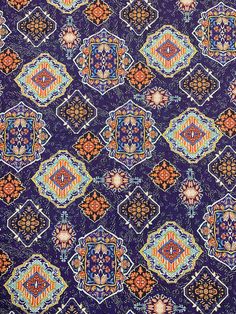 an image of a purple background with many different colors and designs on the fabric,