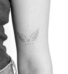 a woman's arm with a small tattoo on the left side of her body