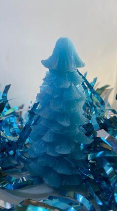 a blue christmas tree is surrounded by streamers