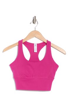 A soft and supportive sports bra features racerback straps and a longline silhouette. Scoop neck Racerback 83% polyester, 17% spandex Machine wash, tumble dry Imported Fitted Racerback Tank Top For Light Sports, Light Exercise Racerback Sports Bra, Pink Activewear With Medium Bust Support And High Stretch, Fitted Pink Sports Bra With Medium Bust Support, Fitted Sports Bra With Built-in Bra For Light Sports, Gym Activewear With Medium Bust Support And T-back, Fitted T-back Sports Bra With Light Support, Supportive Racerback Sports Bra For Light Exercise, Medium Support Racerback Sports Bra For Light Exercise