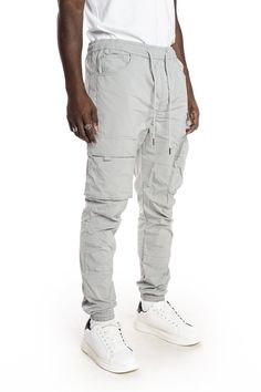 - Slim jogger fit- 100% Polyester- Light Grey- Non-stretchy woven fabric- Metal string tip- Cargo pockets with hidden snap- 3D zipper pocket- Waist size adjustable with elastic band and string New York Streetwear, Slim Joggers, Nylon Pants, Mens Big And Tall, Big And Tall, Waist Size, Color Light, Cargo Shorts, Elastic Band