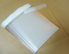 white plastic envelopes are lined up on the table