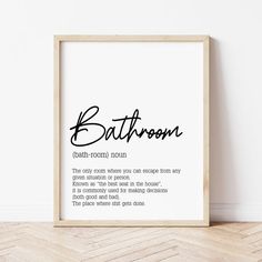 a bathroom print with the words bath room in black and white, on a wooden floor