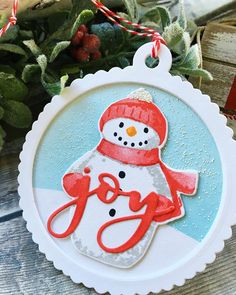 a snowman ornament hanging from a wooden table