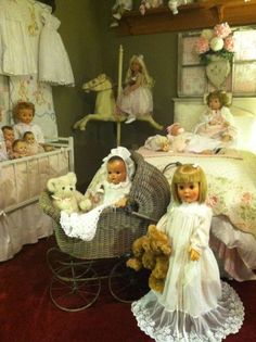 there are many dolls in this room with baby cribs and teddy bears on the floor