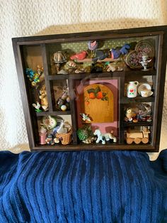 a doll house made out of an old bookcase with lots of toys in it