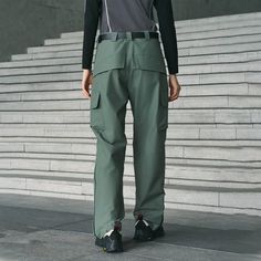 The Multi-Pocket Waterproof Half-Zip Pants seamlessly blend sporty aesthetics with practical functionality. These pants feature large flap pockets on the sides of the thighs and zippered side pockets below the waistband for secure storage. The knee area is designed with crinkled fabric to enhance leg mobility, while zippers extend from the cuffs to the knees, adding a unique touch. Made from premium waterproof fabric, these straight-leg pants ensure durability and comfort, making them an ideal c Practical Outdoor Pants With Pockets, Urban Pants With Functional Pockets For Outdoor Activities, Techwear Hiking Pants With Multiple Pockets, Techwear Pants With Multiple Pockets For Hiking, Techwear Cargo Pants For Outdoor Work, Practical Cargo Pants With Multiple Pockets For Outdoor, Sporty Nylon Pants For Outdoor Work, Urban Pants For Outdoor Activities With Side Pockets, Functional Pants With Side Pockets