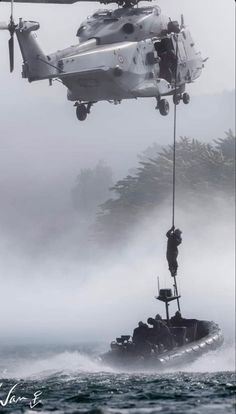 a helicopter flying over a boat in the ocean