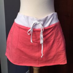 Coral mini skort Coral mini skort (mini skirt with shorts) with MAUI across the behind.  NWT.  Drawstring for adjustable waist.  Size says large but fits smaller sizes. Attitude Clothing Skirts Mini Casual Fitted Mini Skirt With Waistband, Casual Skirt With Waistband For Spring, Spring Casual Skort With Waistband, Casual Skort With Waistband For Spring, Casual Spring Skort With Waistband, Stretch Skort With Pockets For Day Out, Casual Summer Mini Skirt With Waistband, Casual Mini Skirt With Waistband, Casual Summer Skirt With Waistband