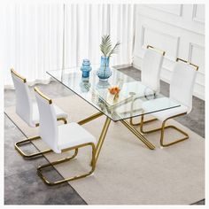 a glass dining table with white chairs around it