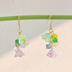 🍀 Size: 4.7 x 2.2 cm 🍀 Material: 14K Gold Plated Sterling Silver Hook, Brass, Glass (✨Hypoallergenic Hook✨) Description 🌸 Introducing our whimsical Cottagecore Rainbow Flower Earrings, a delightful accessory that captures the essence of nature and adds a touch of color and charm to your look. These earrings feature translucent lily of the valley flowers in vibrant rainbow hues, creating a captivating and unique design that embodies the spirit of cottagecore and Y2K fashion. 🌸 ⭐️ Shop more styles at https://etsy.com/uk/shop/StrawberryAtoll. ⭐️ * Shipping *  🇬🇧 Free shipping for UK orders. All our items will be shipped within 1-2 days.  * Packaging & Gift Wrap * 🎀 All our products are packaged with care and attention to detail. To make your purchase even more special, we offer an opti Multicolor Dangle Earrings In Kawaii Style, Kawaii Multicolor Dangle Earrings, Whimsical Dangle Earrings With Flower Charm, Kawaii Drop Earrings, Kawaii Dangle Earrings With Ear Wire, Cottagecore Accessories, Whimsical Cottagecore, Earrings Cottagecore, Cottagecore Earrings