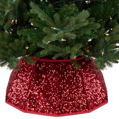 a christmas tree in a red sequined pot with lights on the top and bottom