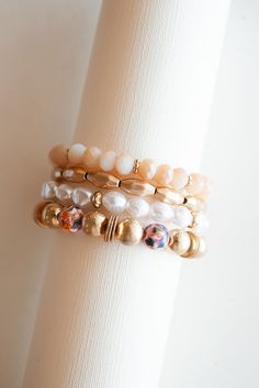 Elevate your wrist with the exquisite Lannie Blush and Gold Beaded Bracelet. This stunning accessory features a captivating combination of delicate pearls and dreamy watercolor-inspired beads, all adorned with elegant gold accents. The graceful interplay of textures and hues creates a timeless yet contemporary aesthetic that effortlessly enhances any ensemble. With its blend of sophistication and artistic charm, the Lannie bracelet is a versatile choice for those who appreciate the beauty of sub Elegant Pearl Bracelet With Colorful Beads, Pearl Bracelet With Spacer Beads, Elegant Crystal Bracelet With Colorful Beads, Adjustable Feminine Pearl Beaded Bracelets, Elegant Multicolor Beaded Pearl Bracelet, Pearl Bracelets With Spacer Beads, Elegant Pearl Bracelets With Colorful Beads, Elegant Multicolor Pearl Beaded Bracelets, Pearl Jewelry With Colorful Beads Bracelet