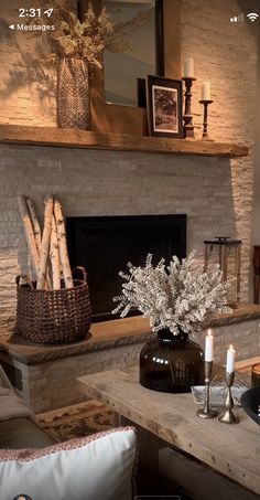 a living room filled with furniture and a fire place in front of a stone fireplace