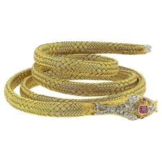 Here we have a excellently crafted gem set snake bracelet from the Victorian era. Crafted in a rich 18ct yellow gold, this antique piece coils around the wearer’s wrist and features a flexible body with a secure steel spring inside. Between an intricately engraved face, razor teeth, pink ruby set head with matching eyes, the attention to detail here is exceptional. The piece is then finished with a diamond set tail and woven textured body befitting the nature of a serpent. Condition: Used (Very Good) Weight: 38.2 grams Size: Small - Large Ladies Wrist Ruby Dimensions: 1 (4mm x 3mm), 2 (1.5mm) Diamond Dimensions: 28 (1mm 0.5mm) Bracelet Width: 24mm (when resting) Individual Coil Width: 6mm Tested As: 18ct Gold Box: Plain Gift Box Face Razor, Victorian Pendant Necklace, Snake Bangle, Flexible Body, Ruby Set, Victorian Pendants, Pink Ruby, Antique Bracelets, Snake Bracelet