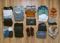 there are many pairs of shoes and clothing laid out on the floor next to each other