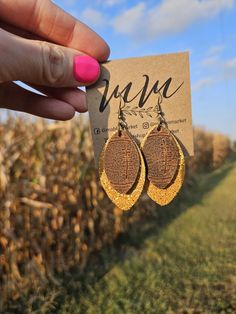 Show off your team spirit with these fun sparkle and embossed football earrings! So cute and lightweight, and can be worn with so many different outfits! Made with genuine leather. The full length of this earring is 2.9" long with a drop length of 2.1", the width measures 1.2" wide. *The pattern of the leather may vary slightly from the photo due to the uniqueness of the leather. Leather pattern is only on the front side of the earrings. Thanksgiving Leather Earrings, Cricut Earrings Football, Faux Leather Cheer Earrings, Kc Chiefs Faux Leather Earrings, Leather Football Earrings, Football Earrings, Diy Leather Earrings, Leather Jewellery, Leather Diy Crafts