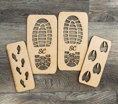 three wooden bookmarks with imprints on them sitting on top of a wood floor