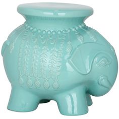 an elephant shaped glass vase sitting on top of a table