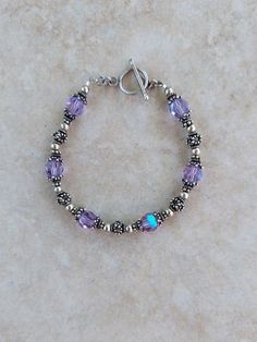 "Sterling Silver 925 and Swarovski Crystal Handmade Bracelet, 7.25\" all beads are sterling silver and Bali sterling silver including toggle clasp. Swarovski crystals are lilac AB 8mm  Any of my handmade jewelry can be adjusted in size, just message me under the listing. Check out my other jewelry at https://loveofjewelryshop.etsy.com" Sterling Silver Crystal Bracelet With Faceted Beads For Gift, Classic Sterling Silver Crystal Bracelet As Gift, Anniversary Silver Beaded Bracelets, Sterling Silver Crystal Bracelet With Silver Beads As Gift, Sterling Silver Beaded Bracelets For Anniversary, Sterling Silver Beaded Bracelet For Anniversary, Sterling Silver Bracelet With Round Beads For Anniversary, Silver Beaded Bracelets For Anniversary, Adjustable Silver Beads Jewelry For Anniversary