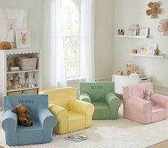 a child's room with various colored chairs and stuffed animals on the floor, including a teddy bear