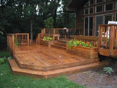 a wooden deck with flower boxes on it