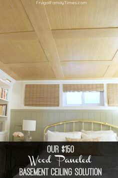 a bed sitting under a wooden ceiling in a bedroom