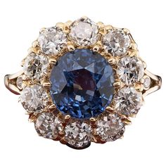 Victorian Tradition Spectacular Victorian period Diamond and Sapphire cluster ring which is in the tradition of the antique jewellery, 1890/1900 ca Hand crafted of solid 18 Kt gold in the classy cluster design in vogue at the time, lovely under-gallery work with an imposing cluster of gems facing up Centrally set with a stunning 3.60 Ct (8.71 x 8.16 mm.) Natural Sapphire of the most saturated Blue colour, 100% unheated /untreated, rare variety, Burma origin, with high degree for the exceptional Luxury Sapphire Diamond Cluster Ring, Luxury Victorian Sapphire Ring In Yellow Gold, Luxury Hallmarked Sapphire Cluster Ring, Luxury Heirloom Sapphire And Diamond Ring, Luxury Victorian Round Sapphire Ring, Antique Sapphire Ring, Antique Sapphire Rings, Sapphire Antique Ring, Sapphire Cluster Ring