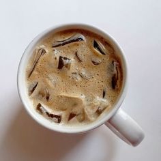 there is a cup of coffee that has some type of liquid in it on the table