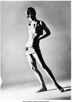 an old black and white photo of a young man in short shorts standing with his hands on his hips