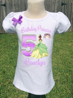 This listing is offers high quality heat pressed tees/baby bodysuit. Shirts are 100% cotton. All shirts are heat pressed and almost all of the tops have a small bow embellishment on the sleeves, shirt design, or on the upper chest. Puffy sleeve tee is available starting 2T to 12 tee.Onesies/Bodysuits are available in Newborn to 24 months. Send me a message for any question, I can personalize you t-shirt for any theme. All items are made in pet-free and smoke - free studio. SHIPPING INFOOur proce Bodysuit Shirts, Princess And The Frog Birthday, Frog Birthday, Princesa Tiana, Princess And The Frog, Princess Tiana, Food Goals, Small Bows, The Princess And The Frog