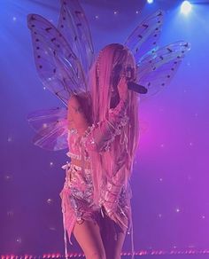 a woman dressed as a fairy on stage