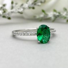 This beautiful ring is made from genuine 925 sterling silver with rhodium plating.Ring details--The Main stone is an oval cut 8mm by 6mm Lab Created Nano Emerald Stone -Side stones are 1.2 Round simulated diamonds -Ring is casted in solid 925 sterling silver with rhodium plating (yellow gold and rose gold plated also available, please check the drop down menu for more options)-The Total face height of the ring measures 8mms and the band width measures 2mms-Each ring is handmade and made to order Green Oval Promise Ring, Oval Solitaire Emerald Promise Ring, Elegant Oval Emerald Promise Ring, Oval Brilliant Cut Emerald Ring As Gift, Classic Oval Emerald Promise Ring, Modern Oval Emerald Ring With Accent Stones, Modern Oval Brilliant Cut Emerald Ring, Engagement Ring Emerald, Simulated Diamond Rings