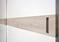 a close up view of the handles on a cabinet door with wood grained finish