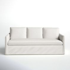 a white couch sitting on top of a white floor