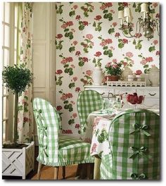 a dining room with green and white checkered table cloths on the chair covers