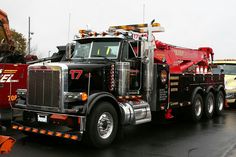 a large tow truck parked in a parking lot