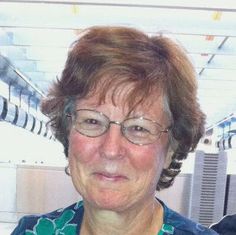 an older woman wearing glasses and a blue shirt