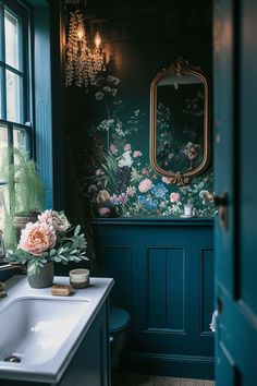 a bathroom with blue walls and floral wallpaper