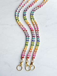 This vibrant teacher lanyard features a delightful mix of colorful beads and natural wood elements. Equipped with a reliable breakaway clasp for safety. Perfect for holding ID badges, keys, or other essentials for easy access. This lanyard is 18.5 inches from breakaway clasps to key ring. Multicolor Lanyard With Keychain For Everyday Use, Multicolor Lanyard With Key Leash For Everyday Use, Multicolor Key Leash Lanyard For Everyday Use, Everyday Multicolor Lanyards With Keychain, Multicolor Lanyards With Key Leash For Everyday Use, Multicolor Beaded Jewelry For Everyday Use, Multicolor Lanyards With Key Leash For Personal Use, Adjustable Multicolor Lanyard With Keychain, Multicolor Badge Holder With Keychain For Gifts