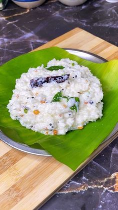 a plate of rice on a wooden cutting board