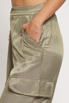 Olive Satin Cargo Pants: a perfect blend of fashion and functionality! Check off all the boxes in your wardrobe with our stylishly woven satin pants, featuring full-length design, cargo pockets, and a convenient zipper front. Get ready to strut the streets with casual chic style! Fabric & fit: 74% Rayon, 26% Polyester Model is wearing size Small. Chic Straight Parachute Pants With Cargo Pockets, Wide Leg Satin Pants With Pockets, Satin Straight Pants With Pockets, Spring Utility Harem Pants With Side Pockets, Utility Harem Pants With Side Pockets For Spring, Chic Ankle-length Cargo Parachute Pants, Khaki Harem Pants With Pockets For Workwear, Spring Satin Pants With Pockets, Chic Parachute Pants With Side Pockets