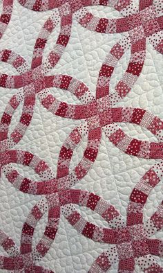 a red and white quilt with dots on it