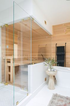 a white bath tub sitting next to a wooden wall